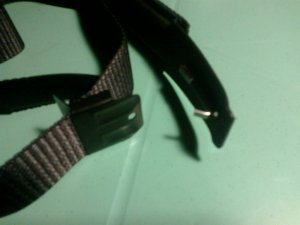 an adjustable metal piece on the other end of the strap, to fit different waist sizes and buckle up the belt.